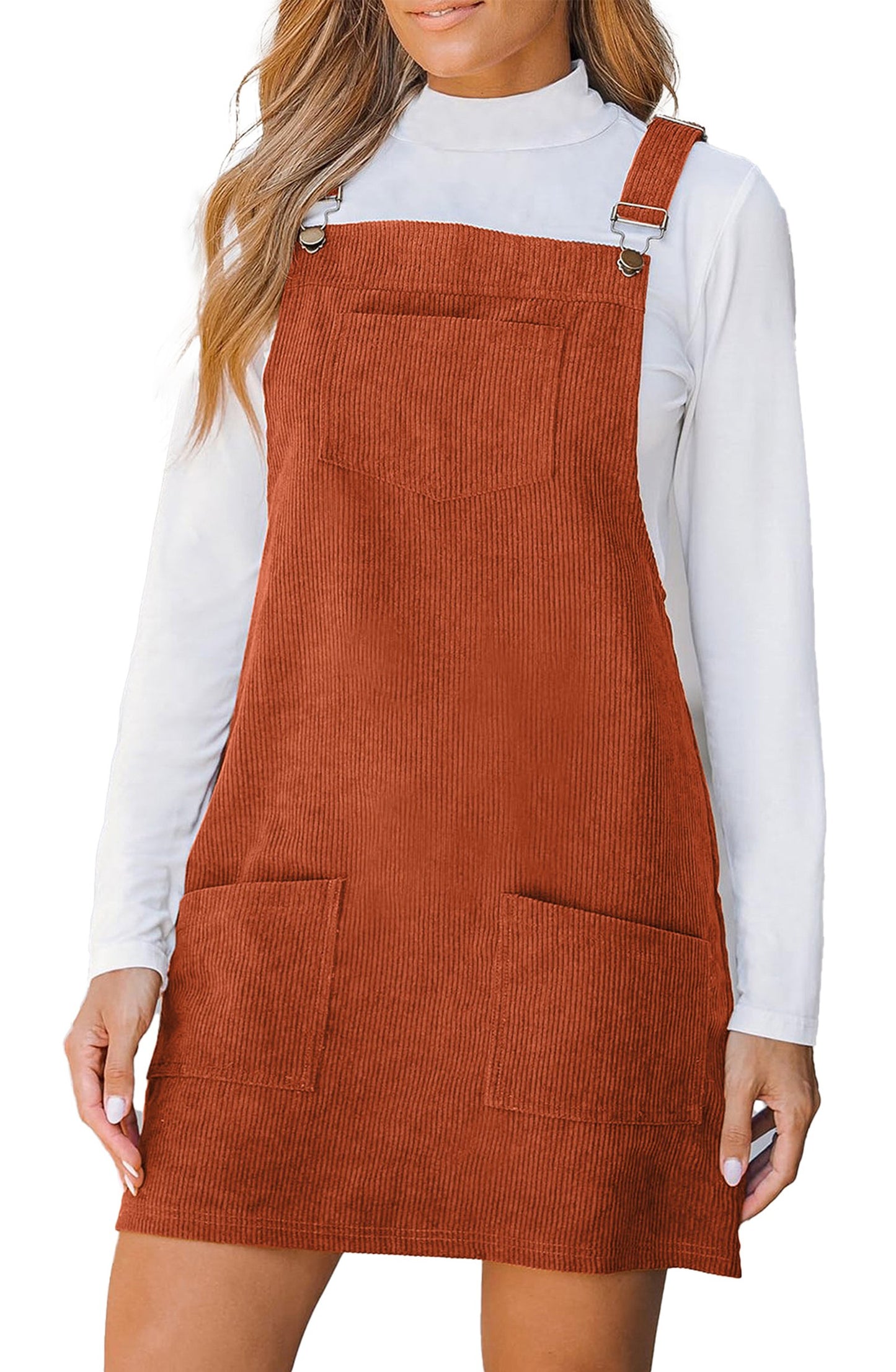 LuckeLadybug vineyard green corduroy overall dress with adjustable straps and front pockets shown in rust over white turtleneck