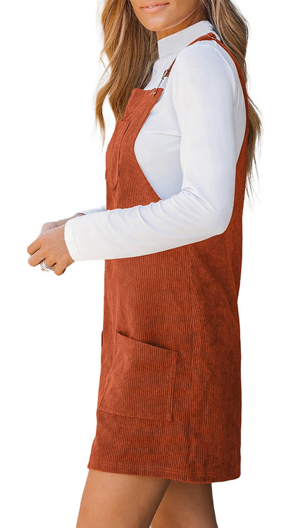 LuckeLadybug vineyard green corduroy overall dress shown in rust corduroy mini with front pocket and straps over white turtleneck