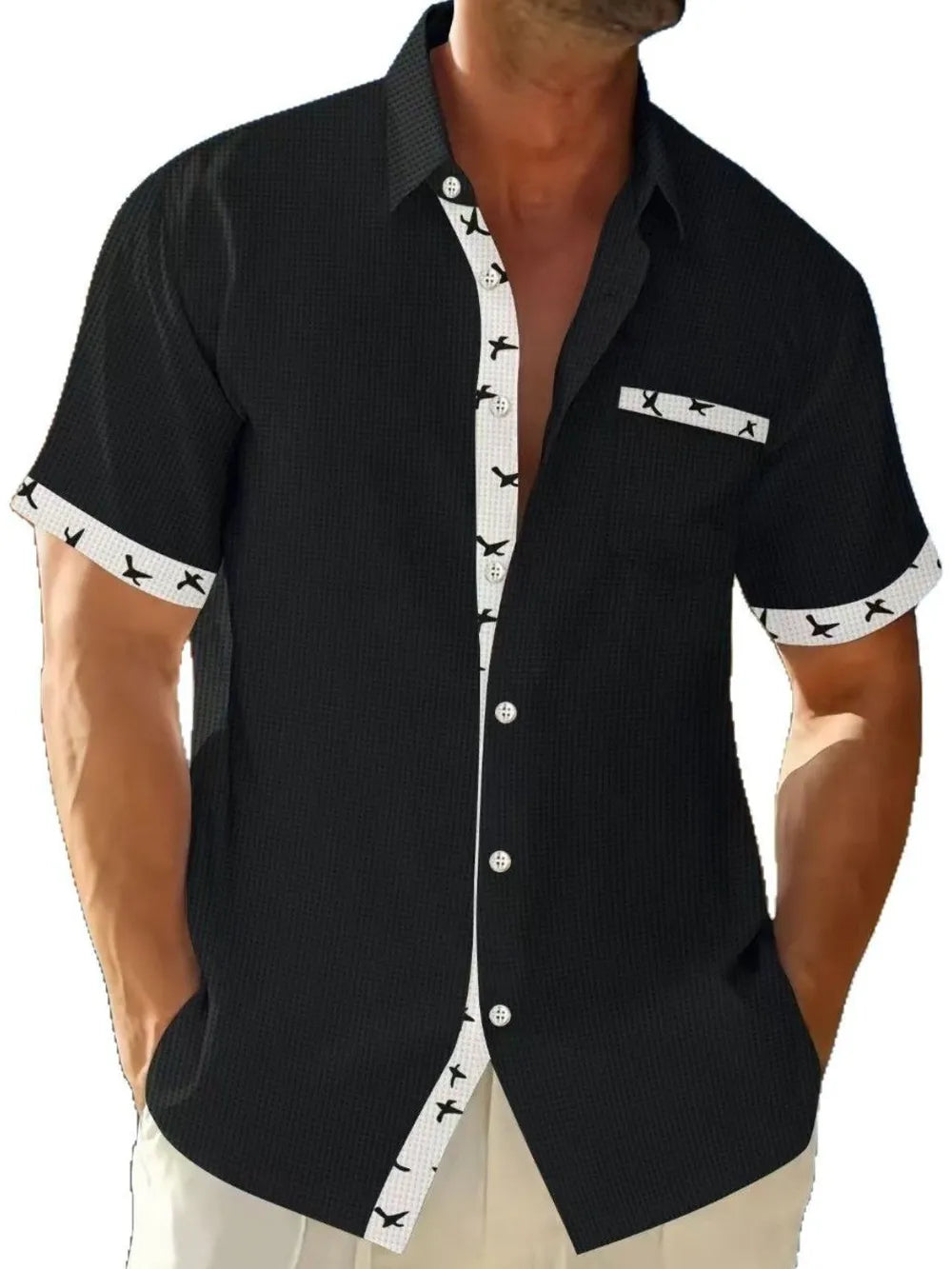 Stylish black short sleeve button down shirt with contrasting patterned cuffs by LuckeLadybug LLC