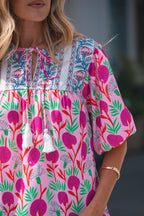 Colorful short sleeve women blouse with floral patterns and tassel details by LuckeLadybug LLC