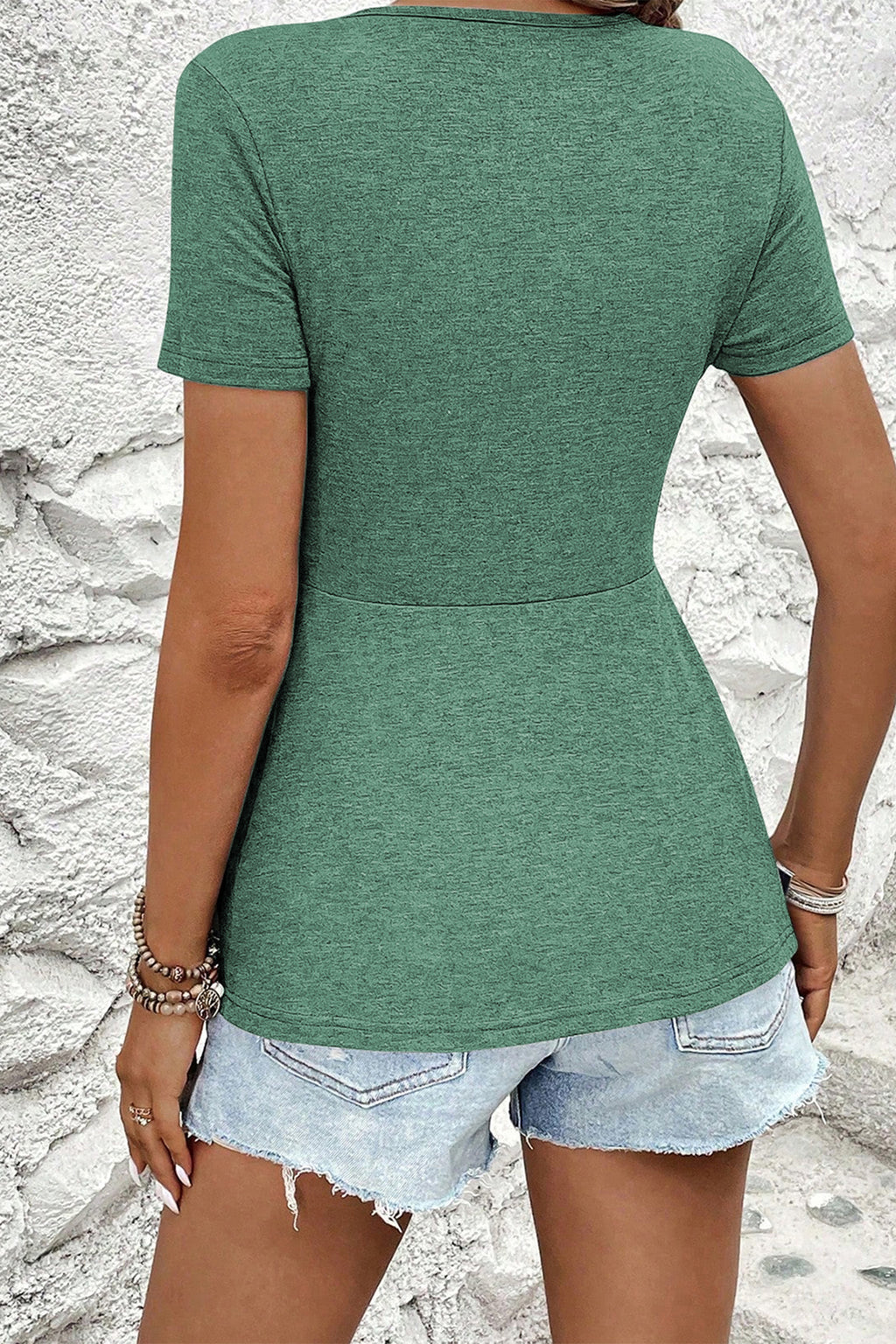 Green short sleeve women blouse with a fitted waist, ideal for casual summer outfits.