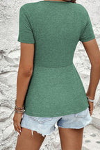 Green short sleeve women blouse with a fitted waist, ideal for casual summer outfits.