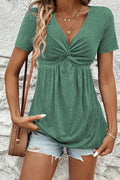 Green short sleeve women blouse with a twisted front and flowy fit for casual wear