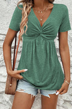 Green short sleeve women blouse with a twisted front and flowy fit for casual wear