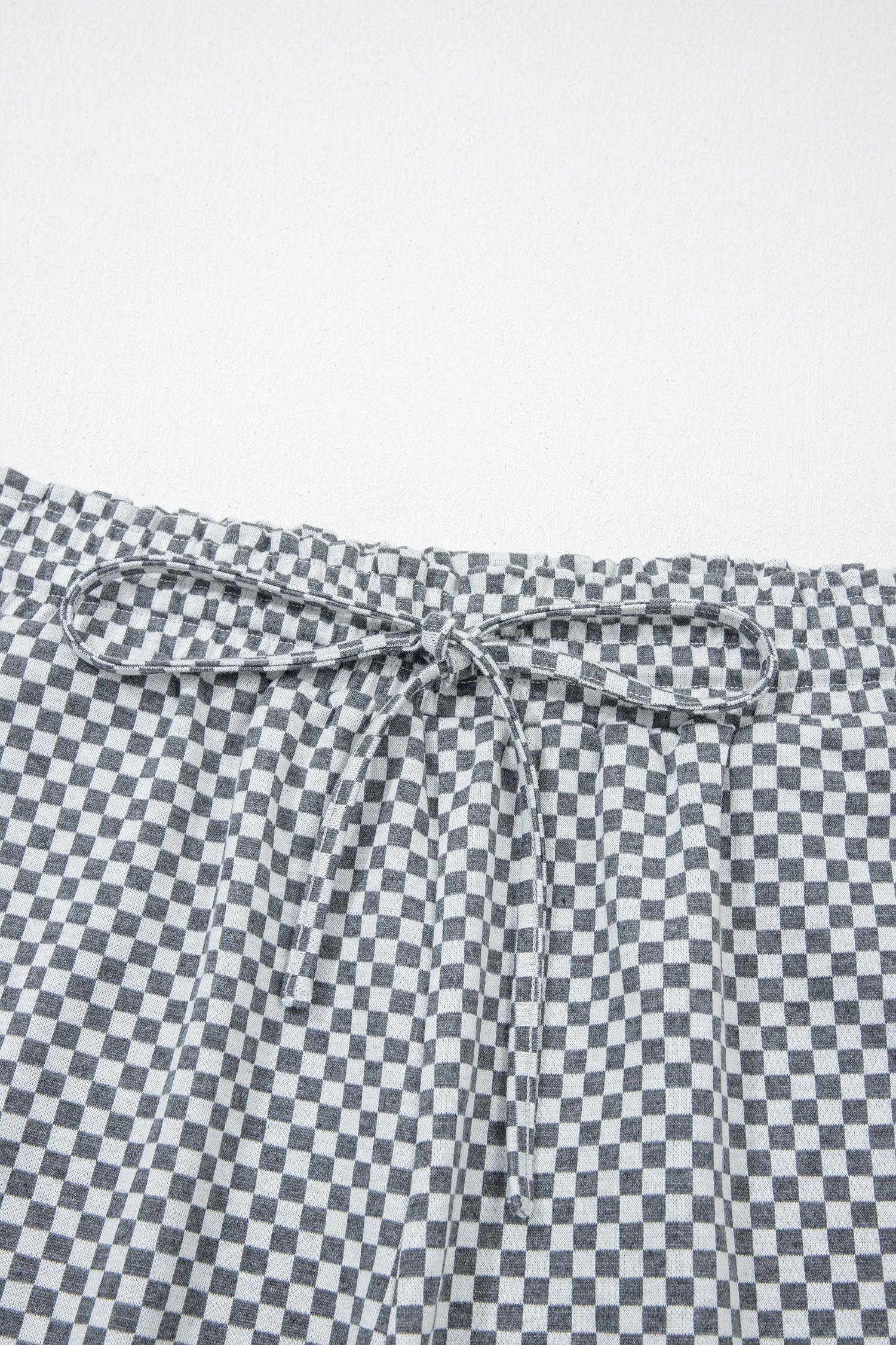 Gray and white checkered drawstring shorts from LuckeLAdybug LLC for comfortable casual wear
