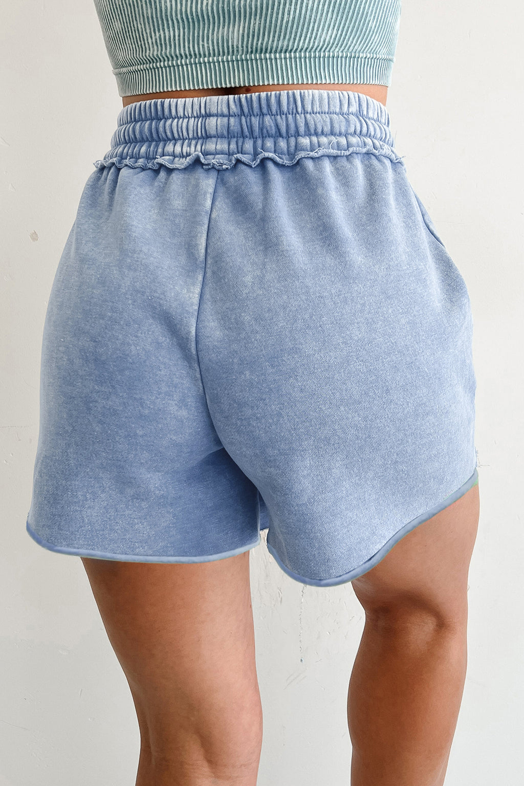Light blue drawstring shorts featuring an elastic waistband and soft fabric for casual wear