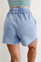 Light blue drawstring shorts featuring an elastic waistband and soft fabric for casual wear