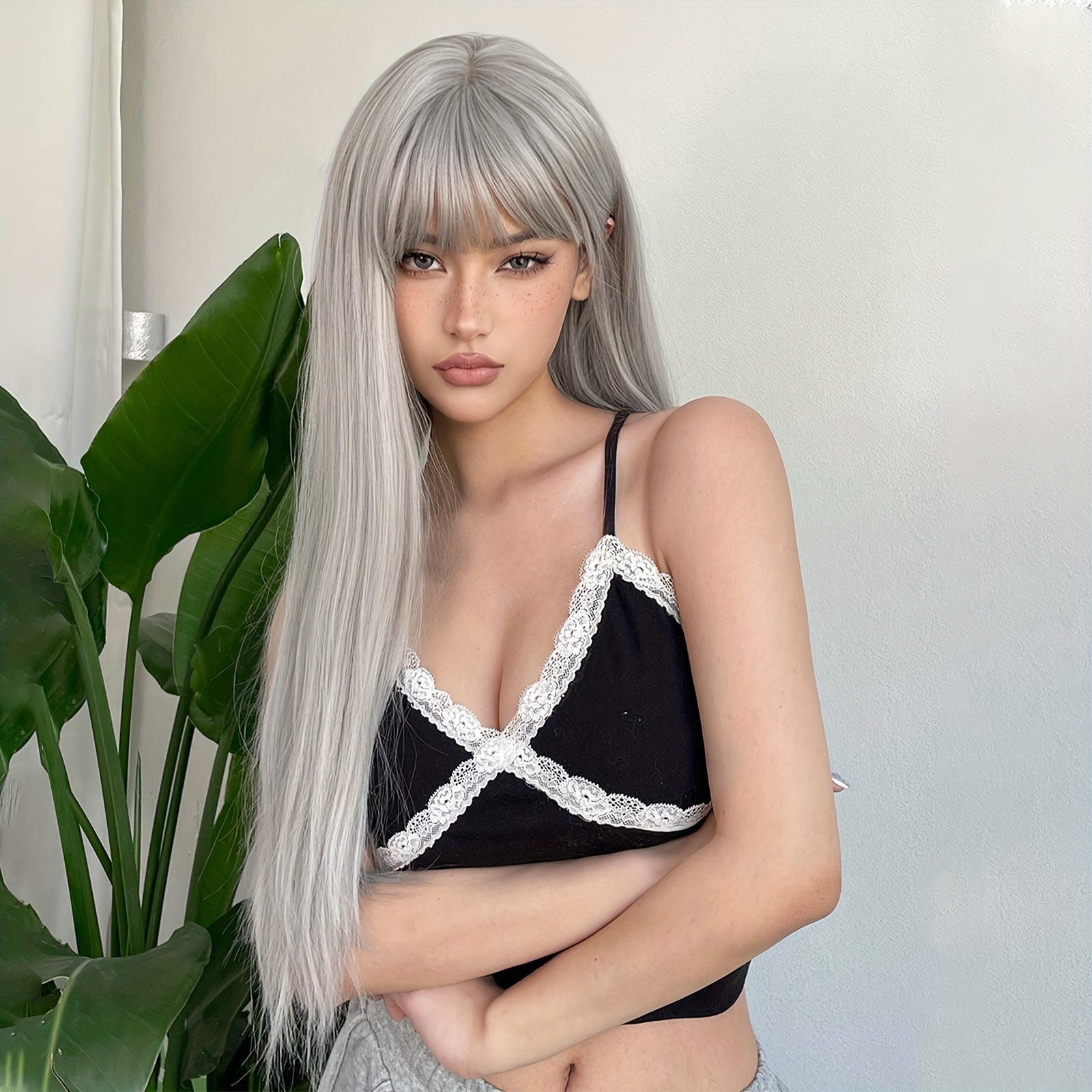 Silvery grey long straight wig by LuckeLadybug LLC styled with bangs for a chic look