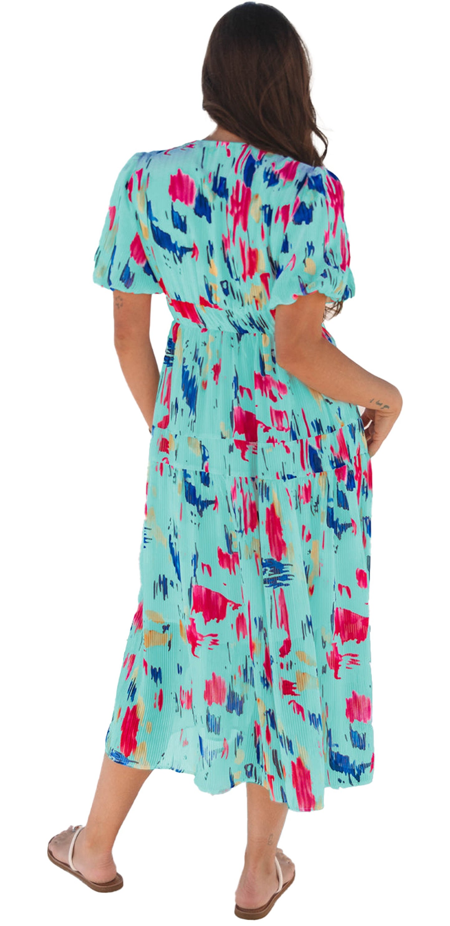 Back view of a woman wearing a sky blue abstract maxi dress with colorful patterns