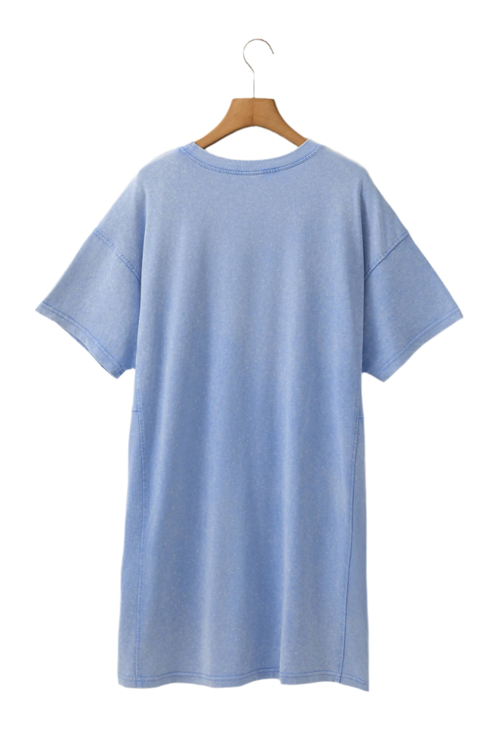 Sky blue t shirt dress by LuckeLadybug LLC hanging on wooden hanger with short sleeves and relaxed fit