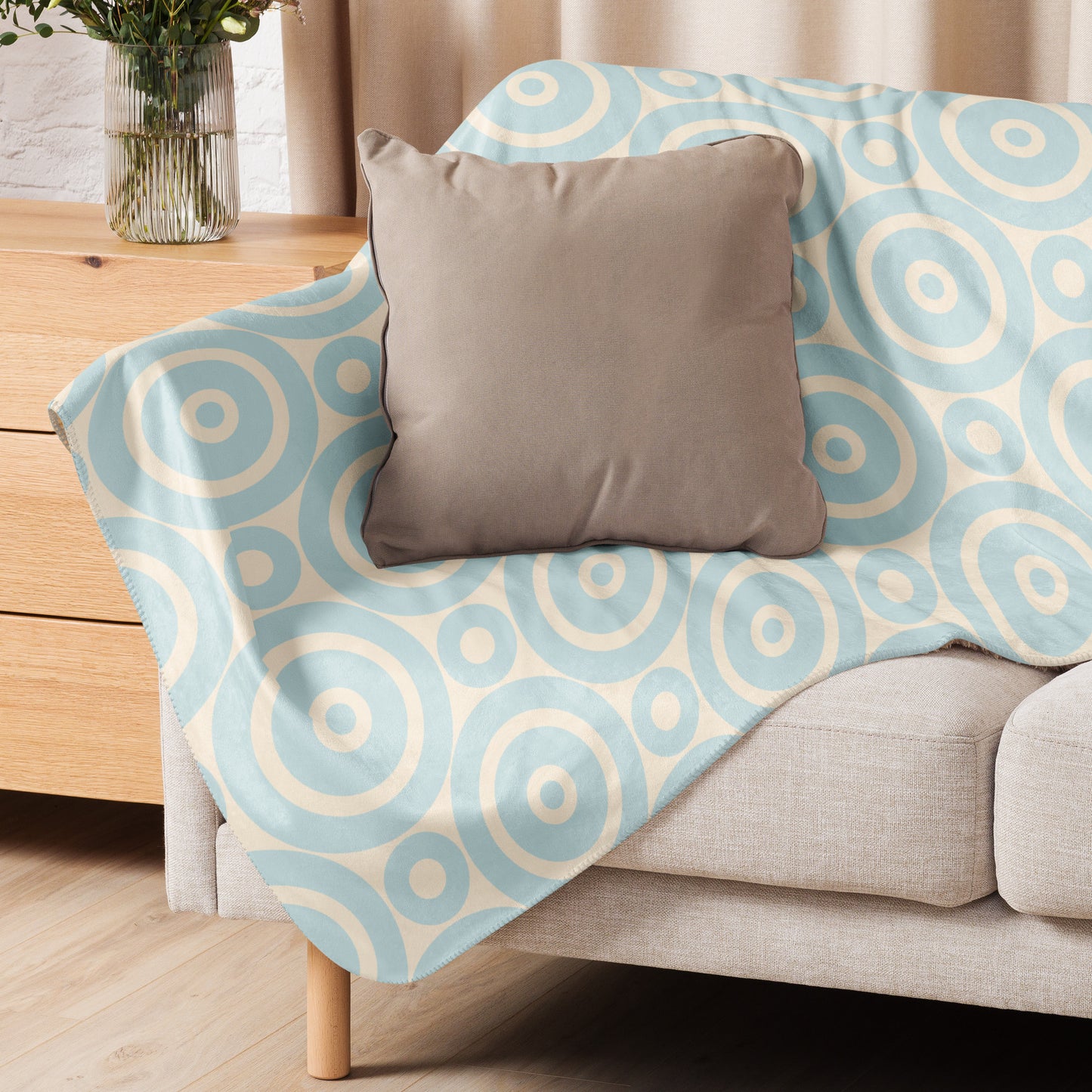 LuckeLadybug Sherpa Blanket with soft circle design throw blanket pattern draped over beige sofa with gray pillow