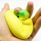 LuckeLadybug squishy toy in yellow and green being squeezed in hand for stress relief