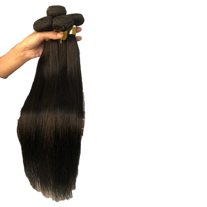 Long straight human hair bundles in dark brown held by a hand for stylish hair extensions