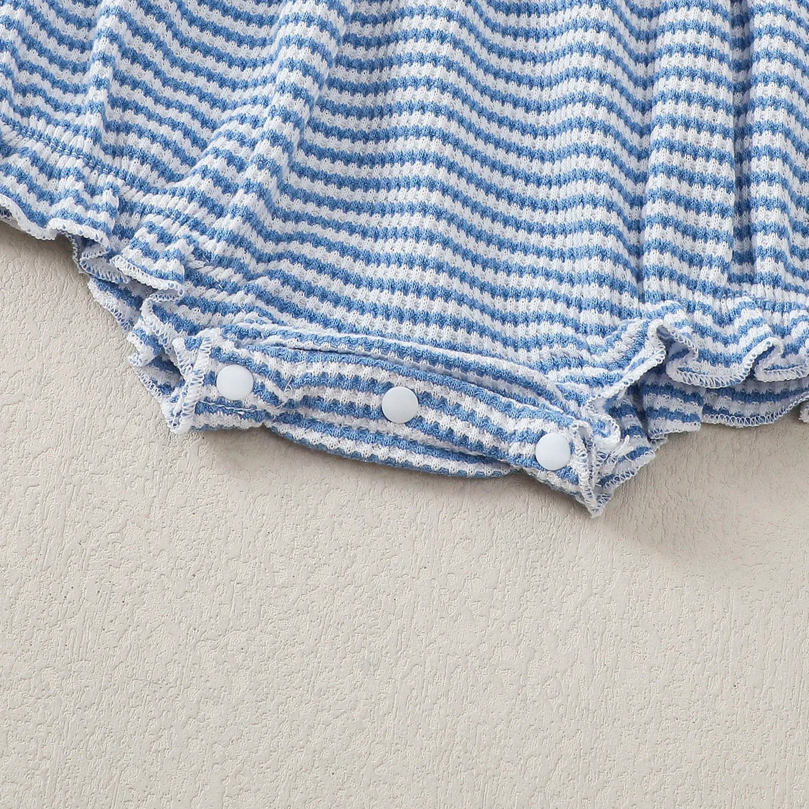 Striped long sleeve baby bodysuit in blue and white with snap closure for easy dressing