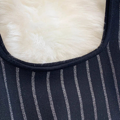 Close-up view of a striped mini dress for women featuring elegant black and silver stripes