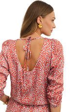 Back view of red leopard print mini dress with open tie back and puff sleeves