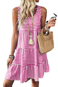Woman wearing pink and white striped sleeveless mini dress holding straw bag for LuckeLadybug black striped mini dress listing
