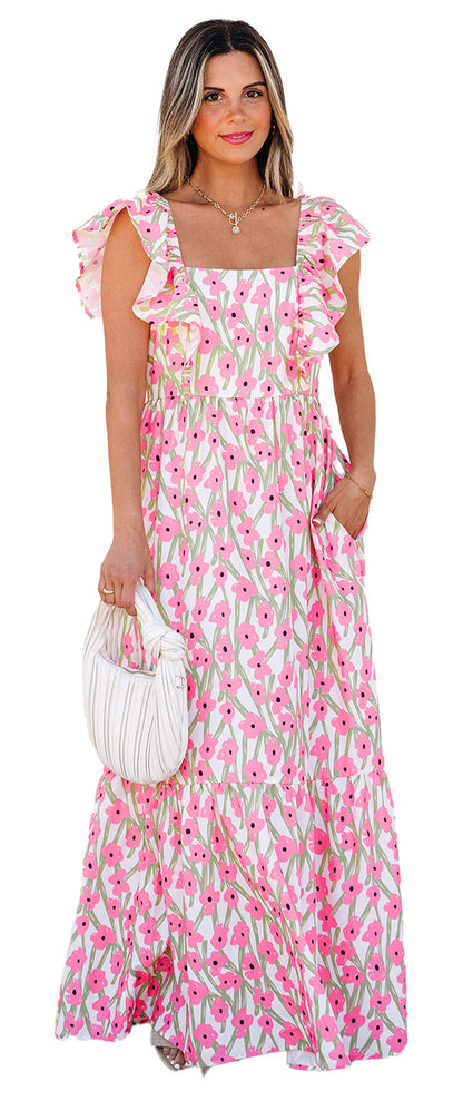LuckeLadybug model wearing a pink floral maxi dress with ruffle straps square neckline and pockets holding a white handbag