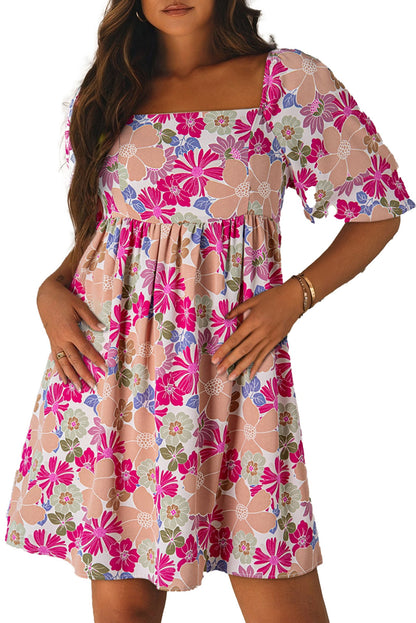 LuckeLadybug pink floral babydoll dress with square neckline puff sleeves and gathered waist on model