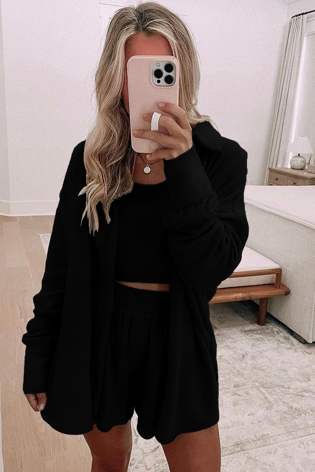 Black shorts styled with a matching top and tank top, perfect for casual summer outfits