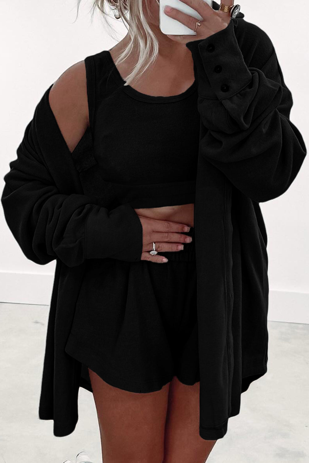 Black shorts paired with a cozy top tank tops and oversized cardigan for a casual look