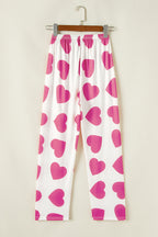 White pants with pink heart prints, perfect to pair with top tank tops for a playful look