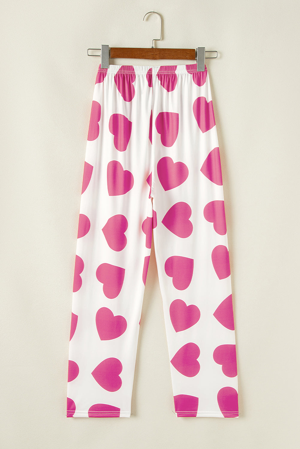 White pants with pink heart prints, perfect to pair with top tank tops for a playful look