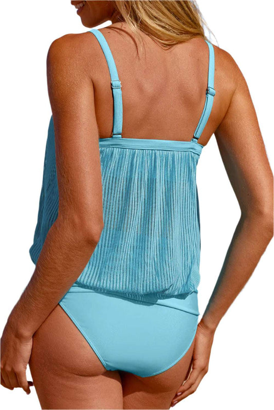 Back view of turquoise tankini swimsuit with adjustable straps worn on beach by LuckeLadybug LLC