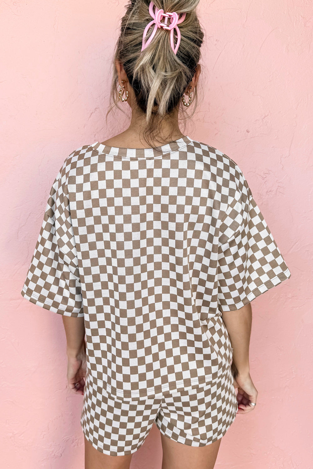 Back view of a woman in a brown and white checkered two piece pants set casual with loose shorts and top