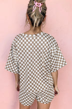 Back view of a woman in a brown and white checkered two piece pants set casual with loose shorts and top
