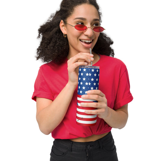 Woman wearing red shirt and sunglasses holding a USA flag tumbler with straw and stars and stripes design