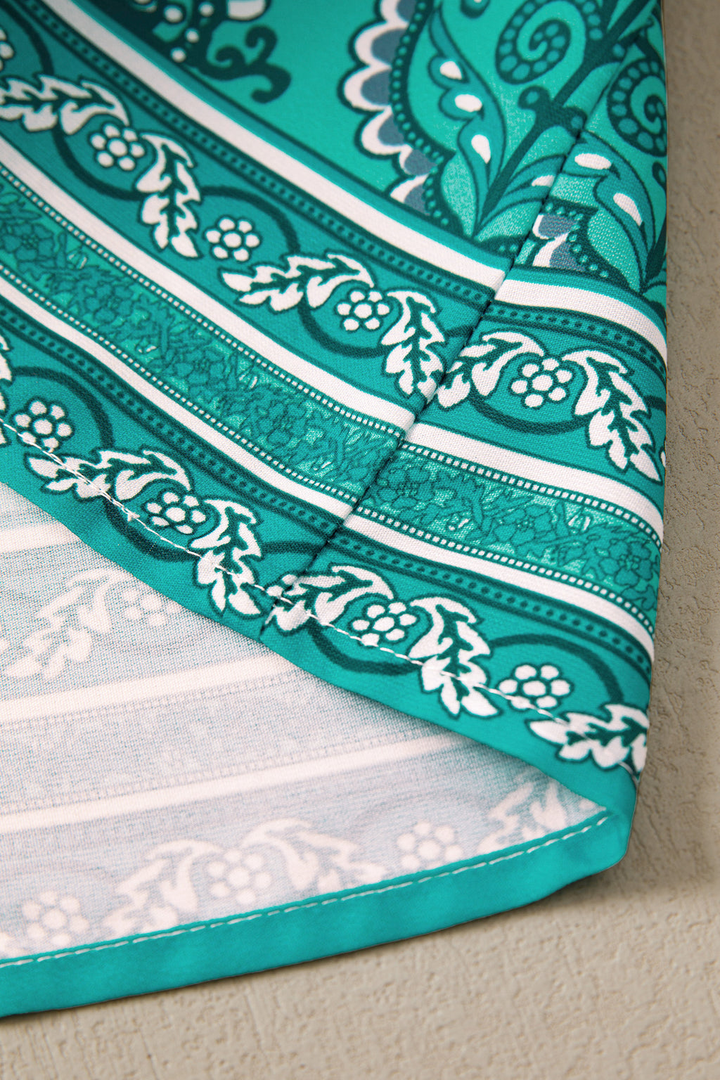 Close-up of LuckeLadybug LLC teal fit & flare design with intricate patterns for a stylish and maxi dress.