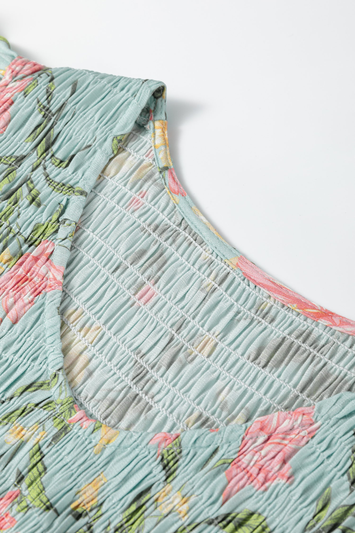 Close-up of floral design on a LuckeLadybug LLC fit and flare maxi dress with textured fabric