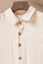 Soft beige cover-up with button details, perfect for beachwear and maxi dress layering.
