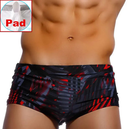 LuckeLadybug LLC Brazilian men's swimwear with padded support and vibrant red-black design