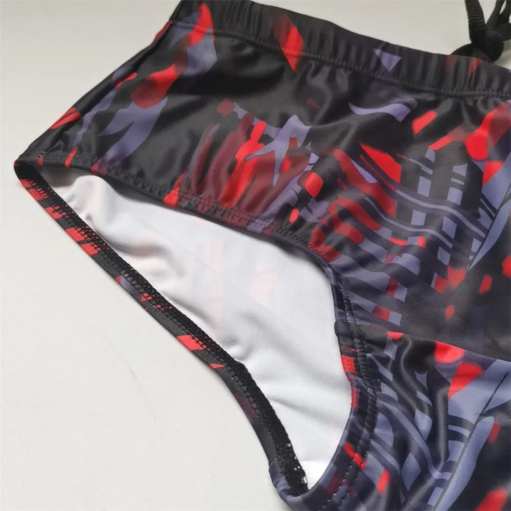 LuckeLadybug Brazilian men's swimwear featuring a vibrant red and black abstract pattern