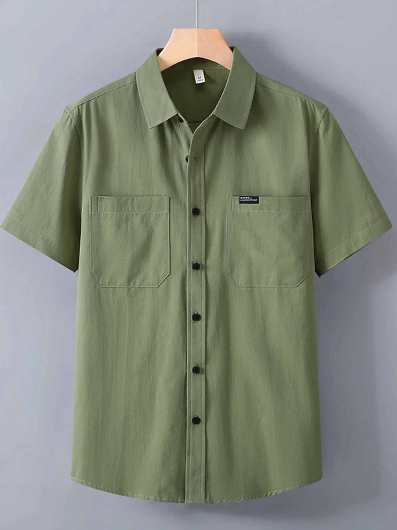 Light green button up shirt for men with two chest pockets and short sleeves