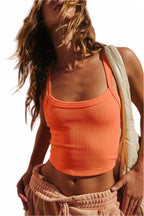 LuckeLadybug grapefruit orange cropped cami top worn by model with casual pants and sleeveless jacket