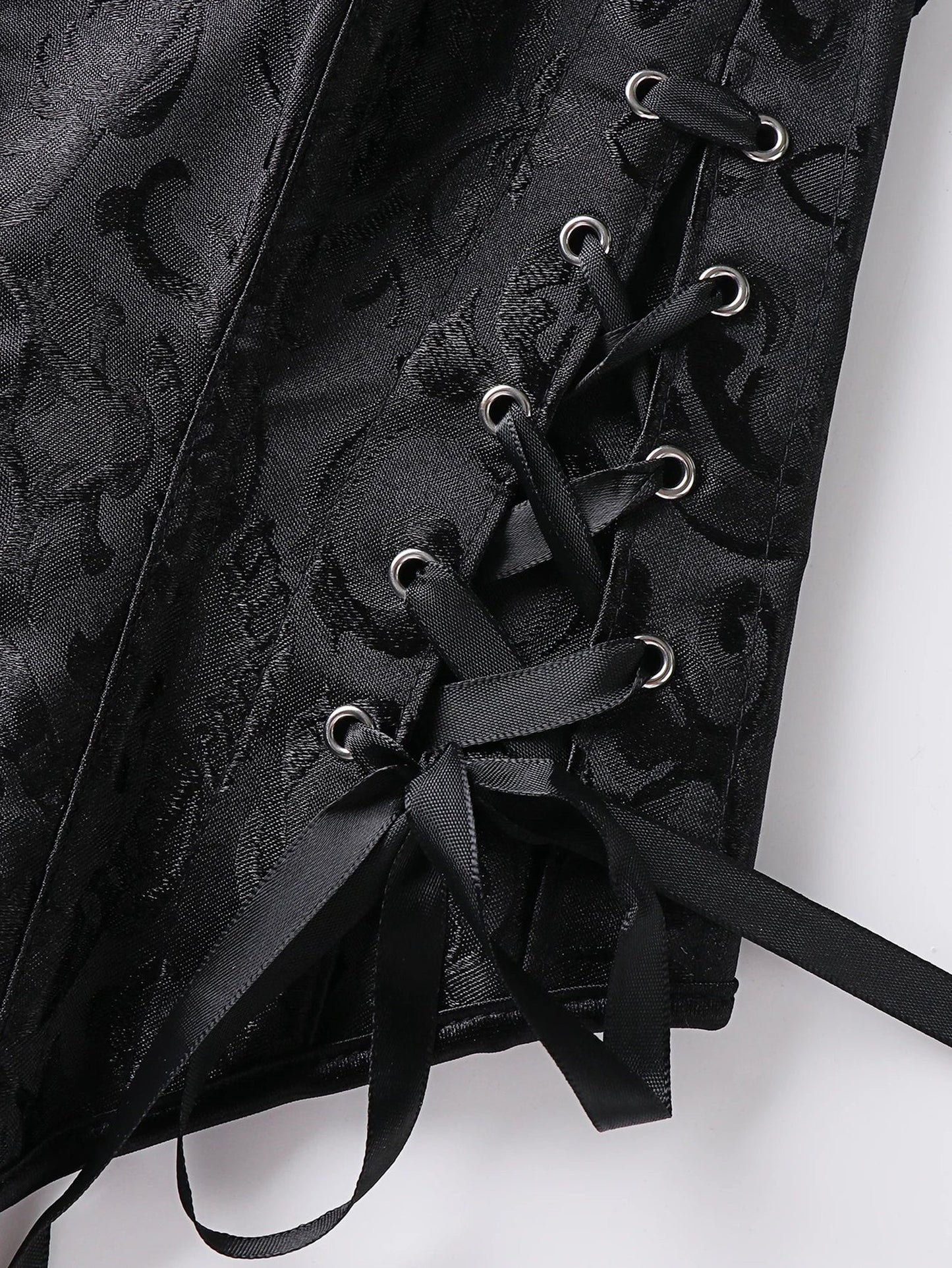 Close-up of black lace trim double halter corset featuring intricate lace-up detailing