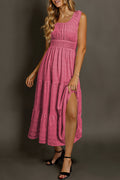 Pink midi dress with smocked bodice and tiered skirt, perfect for summer occasions
