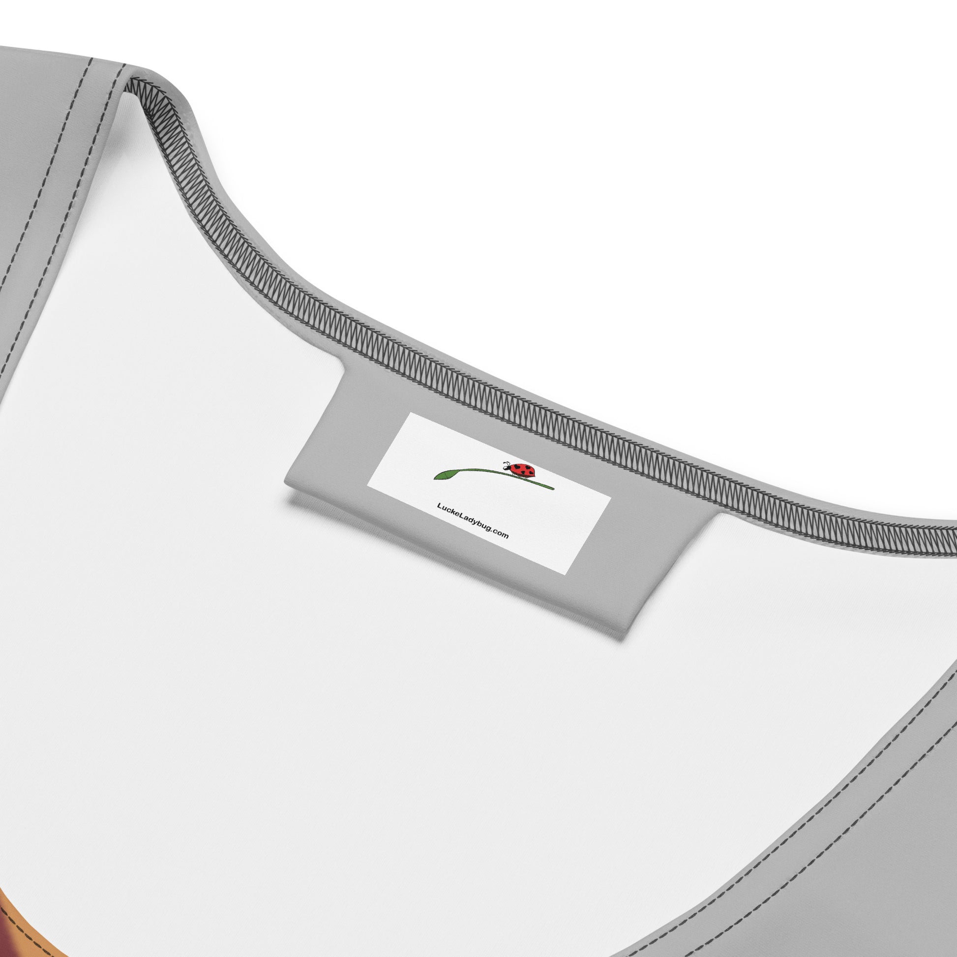 Close-up of LuckeLadybug label inside a patterned bodycon dress online showing neckline and stitching details