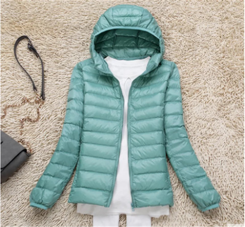 Light teal plus size women puffer jacket with a hood for warm winter wear