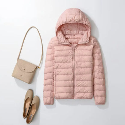 Light pink plus size women puffer jacket with a hood, paired with a handbag and shoes