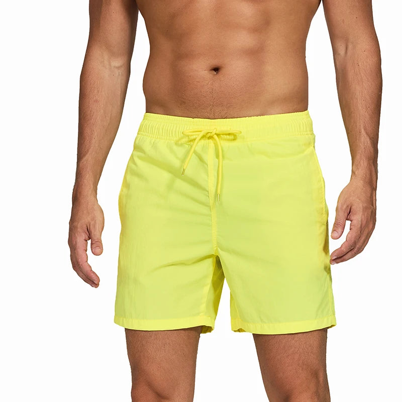 Bright yellow swim shorts men from LuckeLadybug LLC perfect for beach and pool activities
