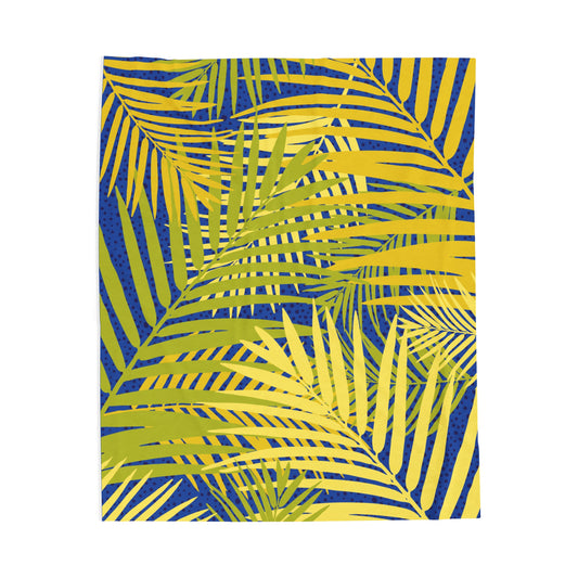 LuckeLadybug tropical palm print blanket with green and yellow palm leaves on blue background