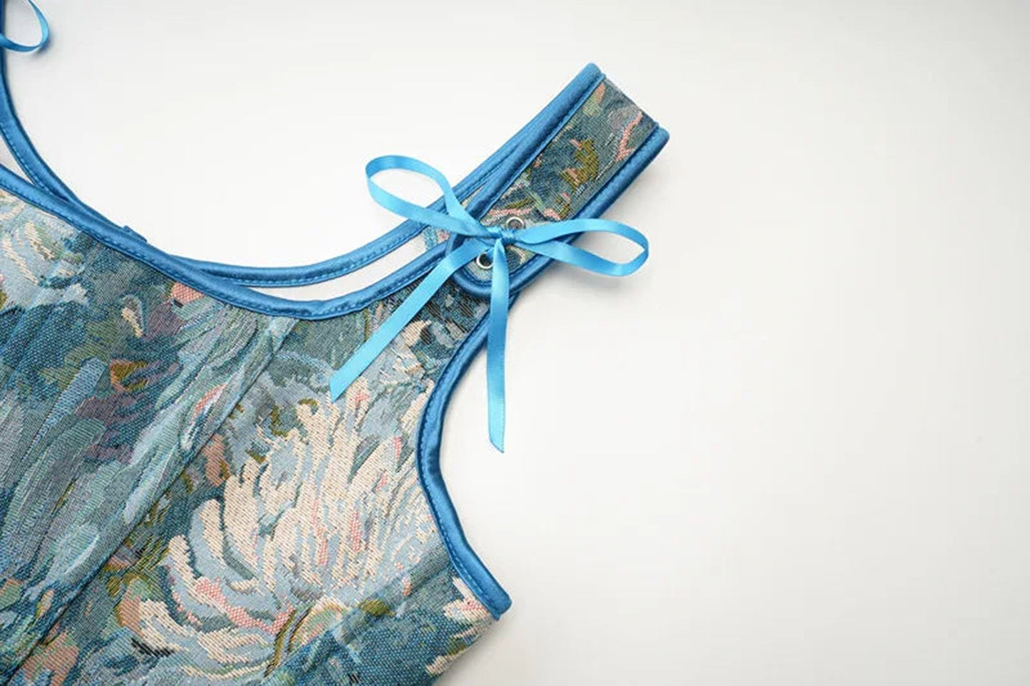 Elegant floral design of a blue Victorian corset top for women with decorative tie detail