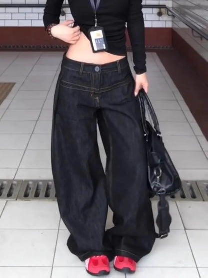 Women wearing vintage washed wide leg jeans women with a black top and sneakers for a casual look
