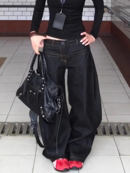 Women wearing vintage washed wide leg jeans women paired with a stylish black bag and red shoes