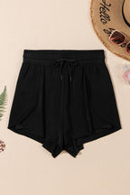 Black LuckeLadybug LLC boardshorts with a drawstring waist, perfect for beach days and summer fun, waisted jeans high