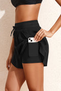 Black boardshorts with side pocket, perfect for summer, paired with waisted jeans high style